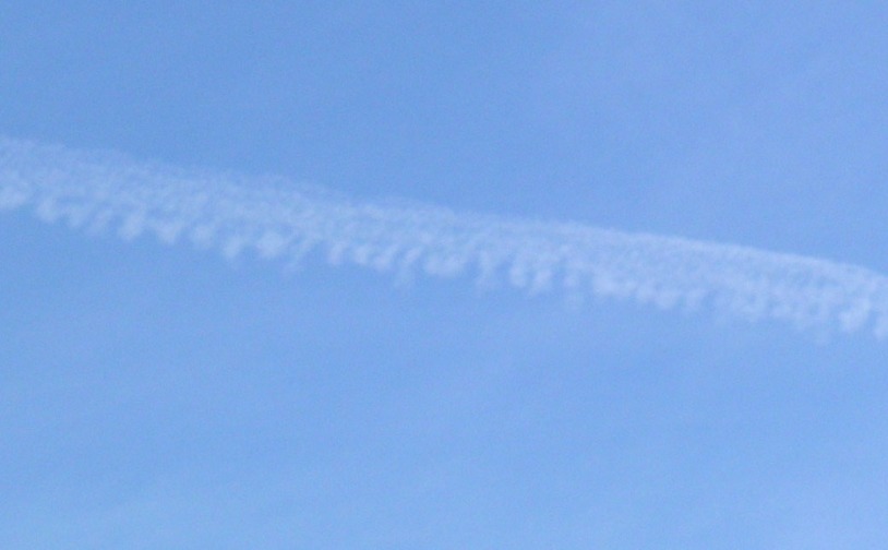 Close up of chemtrail. Notice puffs on one side as it just starts to spread.